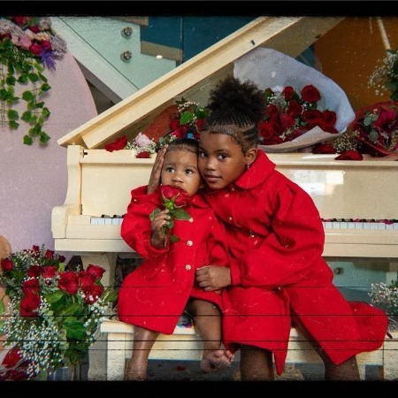 Iman Tayla Shumpert Jr and her baby sister Rue Rose Shumpert in matching red outfit.